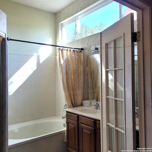 bathroom with shower / bath combo with shower curtain and vanity