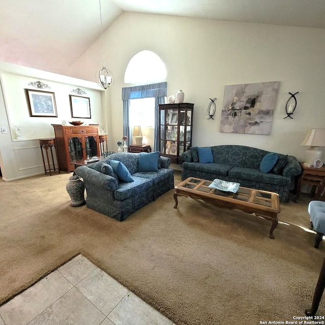 tiled living room featuring high vaulted ceiling