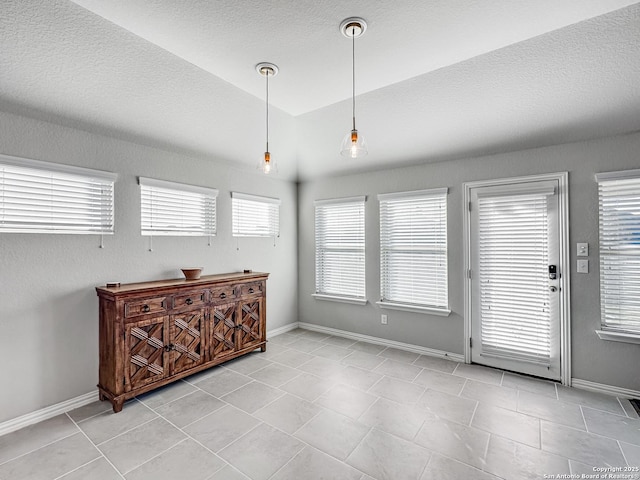 tiled dining room with lofted ceiling