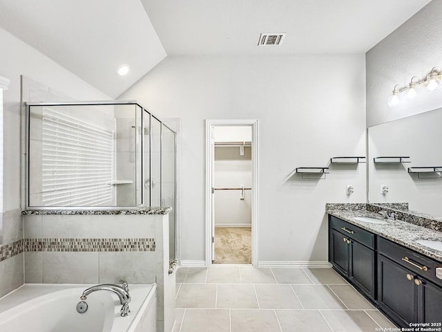 bathroom featuring tile patterned floors, vanity, plus walk in shower, and vaulted ceiling