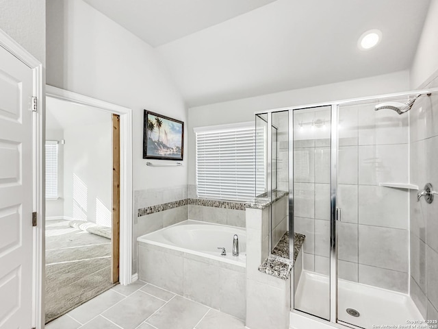 bathroom featuring tile patterned flooring, shower with separate bathtub, and lofted ceiling