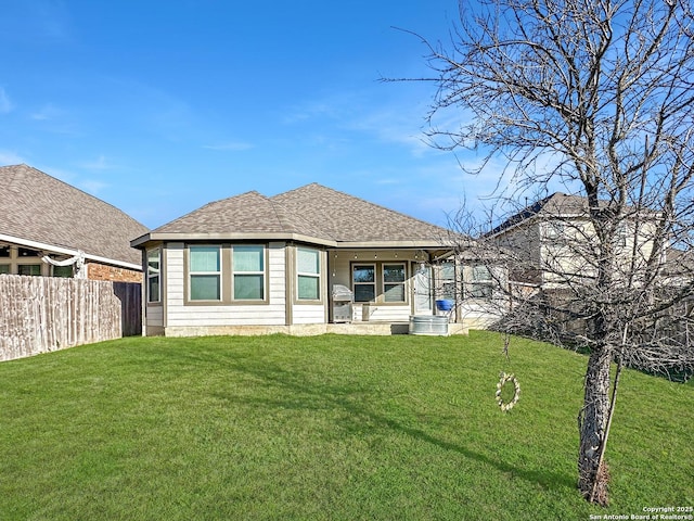 rear view of property with a yard