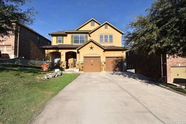 view of front of property featuring a front yard and a garage