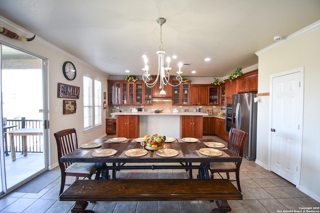 dining space featuring a notable chandelier, light tile patterned flooring, and ornamental molding