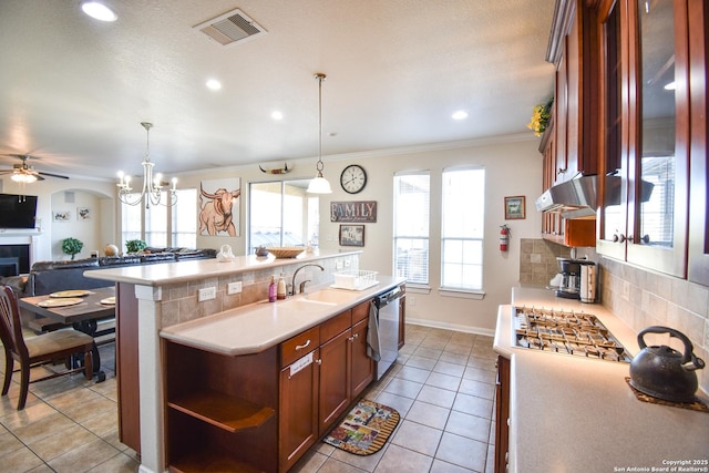 kitchen with pendant lighting, ceiling fan with notable chandelier, stainless steel dishwasher, and sink