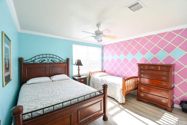 bedroom with light hardwood / wood-style flooring, ceiling fan, and ornamental molding