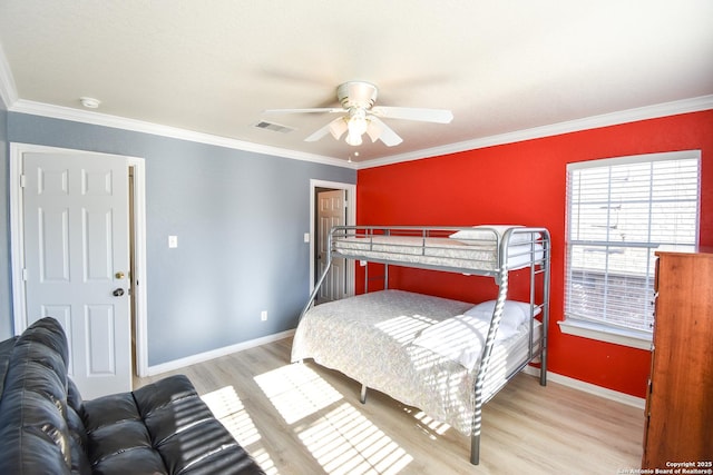 bedroom featuring light wood-type flooring, ceiling fan, and ornamental molding