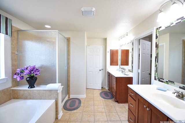 bathroom with tile patterned floors, vanity, and independent shower and bath