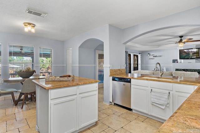 kitchen with ceiling fan, sink, white cabinets, and stainless steel dishwasher