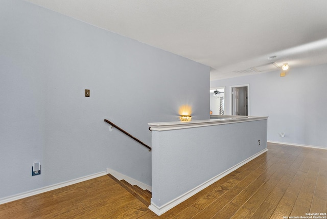 stairs with hardwood / wood-style flooring