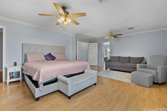 bedroom with ceiling fan, light wood-type flooring, and ornamental molding