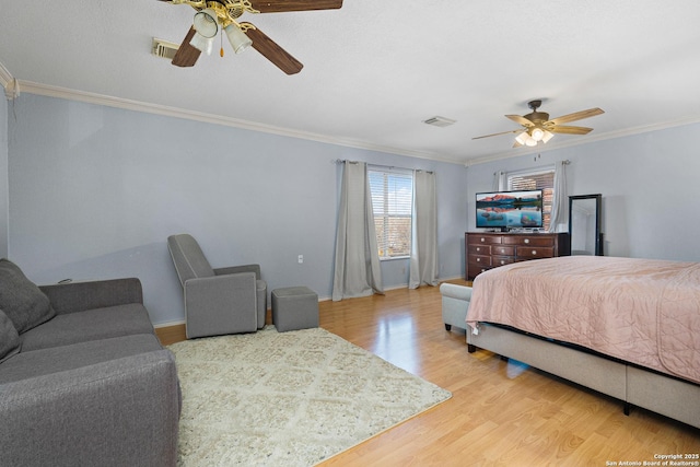 bedroom with ceiling fan, wood-type flooring, and crown molding