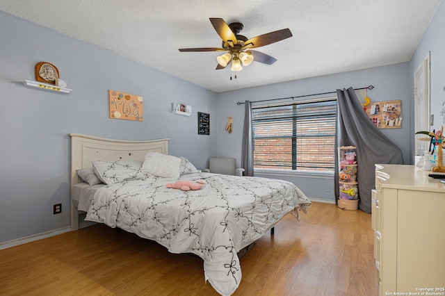 bedroom with light wood-type flooring and ceiling fan