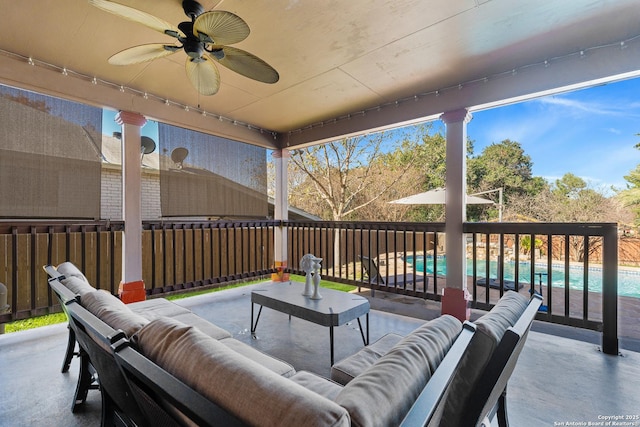 view of patio / terrace with a fenced in pool, ceiling fan, and an outdoor hangout area