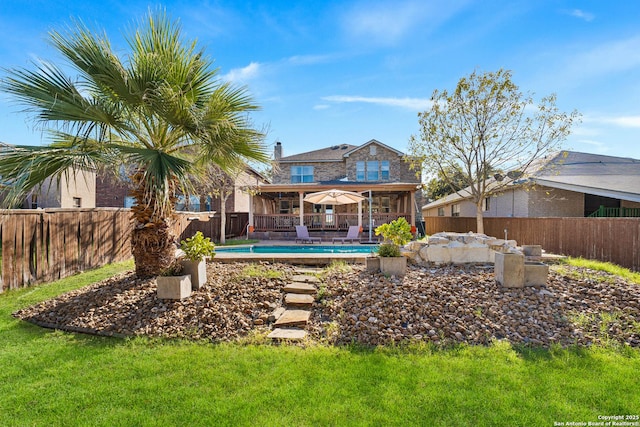 back of property featuring a yard, a fenced in pool, and a patio area