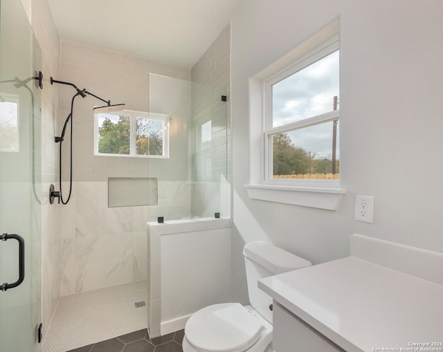 bathroom with toilet, vanity, tile patterned floors, and an enclosed shower