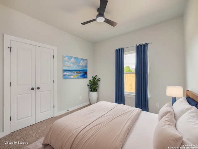 bedroom featuring carpet, ceiling fan, and a closet