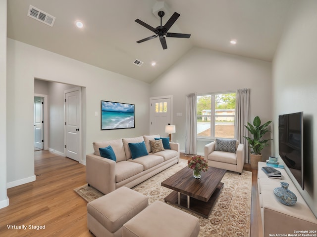 living room with ceiling fan, high vaulted ceiling, and light hardwood / wood-style flooring