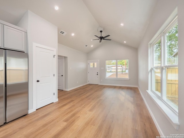 unfurnished living room featuring ceiling fan, light hardwood / wood-style flooring, and lofted ceiling