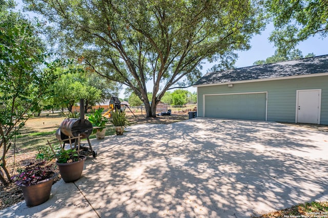 view of property exterior featuring an outdoor structure and a garage