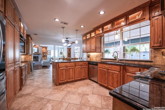 kitchen with kitchen peninsula, pendant lighting, decorative backsplash, and dishwasher