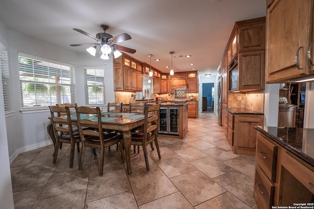 tiled dining space with ceiling fan and beverage cooler