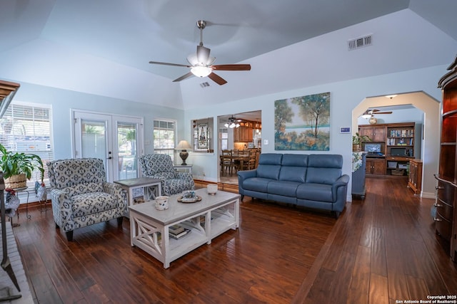 living room with french doors, dark wood-type flooring, and lofted ceiling