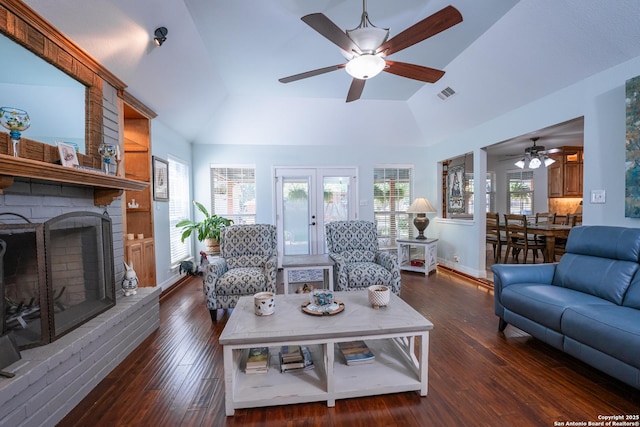 living room featuring a fireplace, dark hardwood / wood-style flooring, vaulted ceiling, and ceiling fan