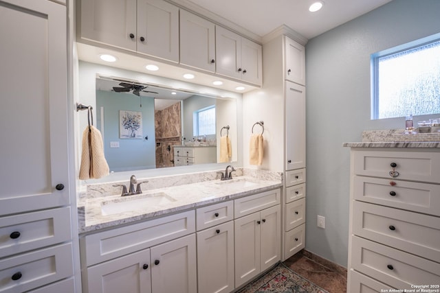 bathroom with ceiling fan and vanity