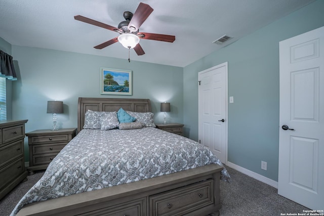 bedroom with ceiling fan and dark colored carpet