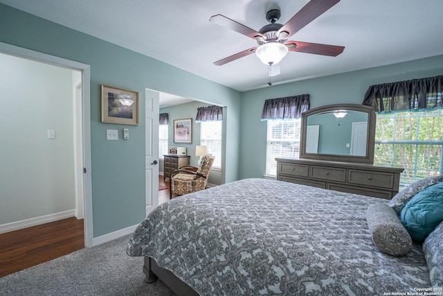 bedroom with dark colored carpet and ceiling fan