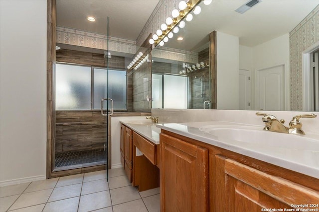 bathroom with tile patterned flooring, vanity, and a shower with door