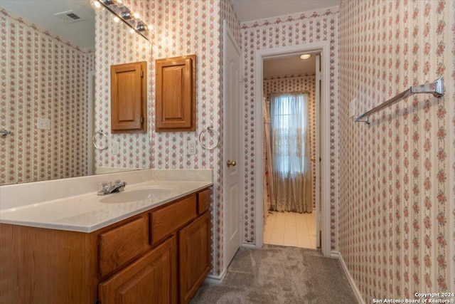 bathroom with tile patterned floors and vanity