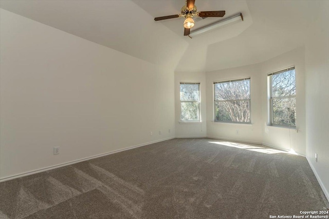 unfurnished room featuring ceiling fan, carpet floors, and vaulted ceiling