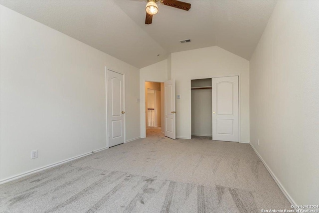 unfurnished bedroom with light colored carpet, ceiling fan, and lofted ceiling