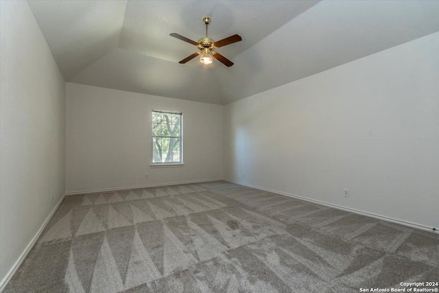 unfurnished room with light carpet, vaulted ceiling, and ceiling fan