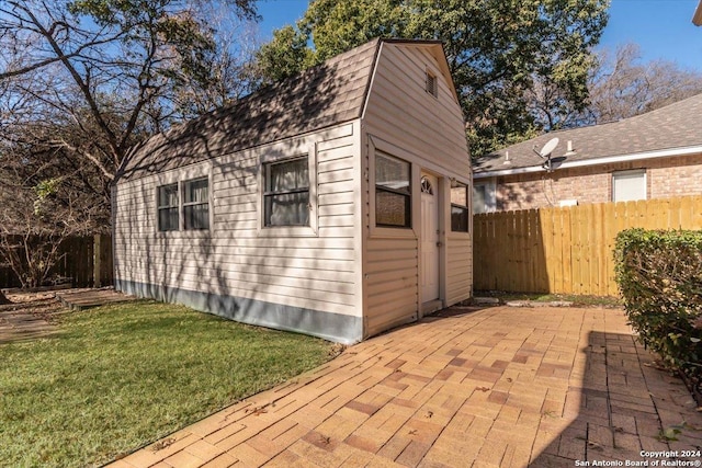 view of outbuilding with a yard