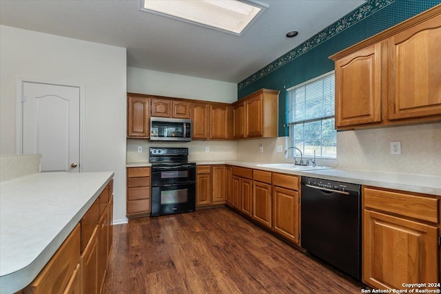 kitchen featuring decorative backsplash, dark hardwood / wood-style flooring, sink, and black appliances