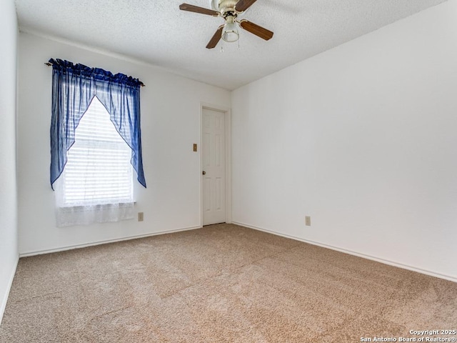 spare room with ceiling fan, carpet flooring, and a textured ceiling