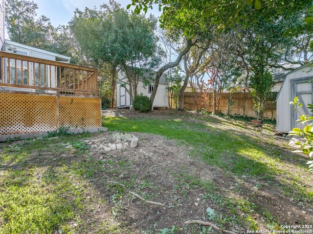 view of yard with a storage shed and a deck