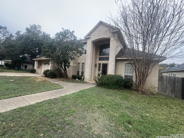 view of front of home with a front yard and a garage