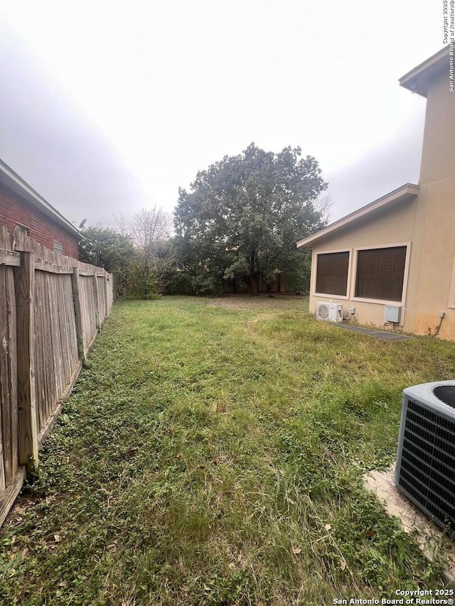 view of yard featuring central air condition unit