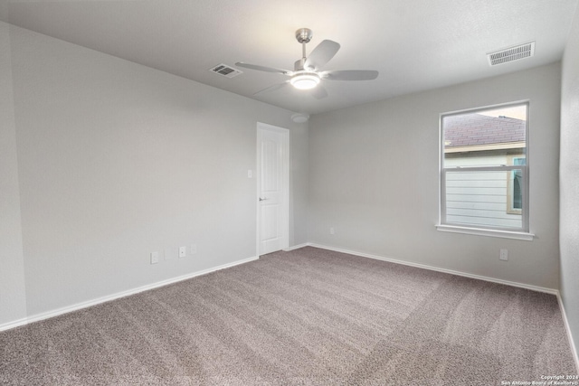 spare room with ceiling fan and carpet floors