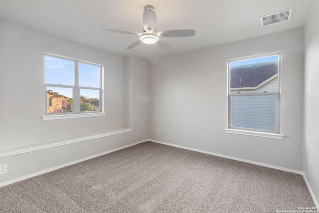 carpeted spare room with ceiling fan