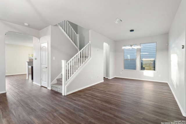 unfurnished living room featuring dark hardwood / wood-style flooring