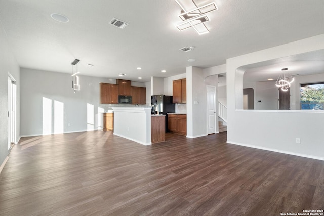 kitchen featuring pendant lighting, dark hardwood / wood-style floors, a kitchen island, and black appliances