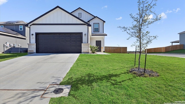 view of front of house featuring a front yard and a garage