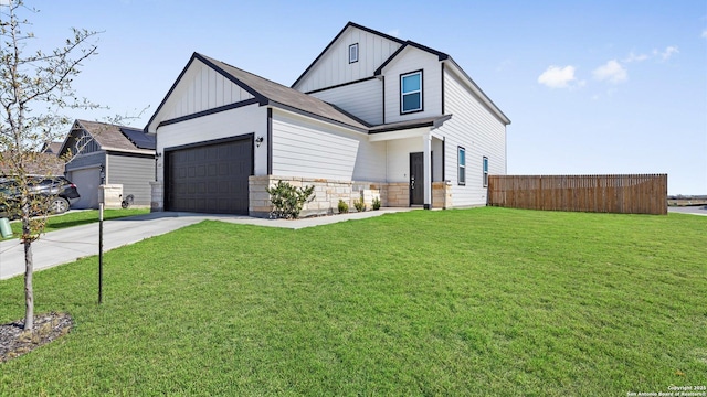 view of front of house featuring a garage and a front lawn