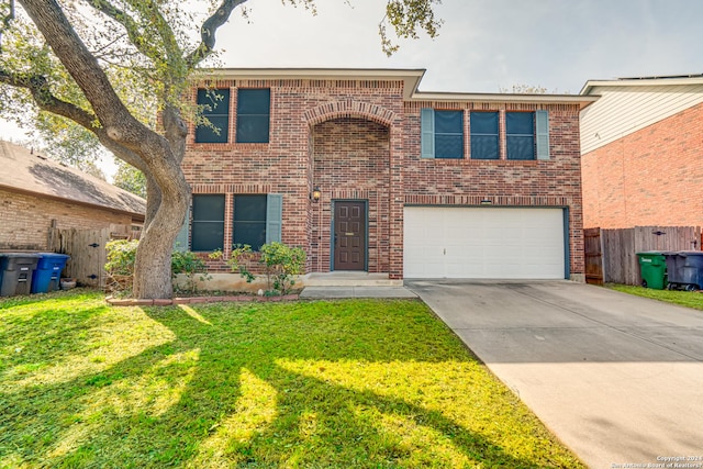 view of front of property with a garage and a front lawn