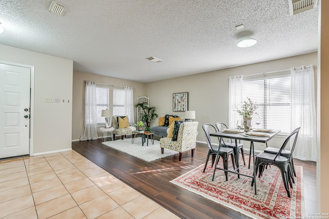 tiled dining room with a textured ceiling